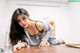 A woman laying on top of a wooden table.