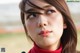 A close up of a woman's face with long brown hair.