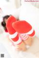 A pair of red and white striped socks sitting on top of a bed.