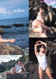 A woman in a white bathing suit sitting on a rock by the ocean.