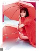 A woman in a red dress holding an umbrella.